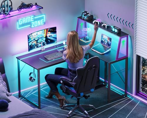 MOTPK 45 Inch L Shaped Gaming Desk with Power Outlet & LED Lights, Computer Table with Corner Desktop Showcase for CPU Stand, Display Storage Shelf, Carbon Fiber Surface, Black MOTPK