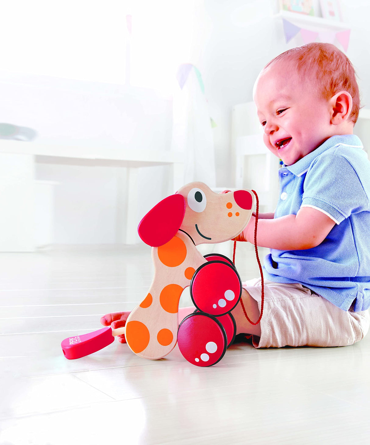 Walk-A-Long Puppy Wooden Pull Toy by Hape | Award Winning Push Pull Toy Puppy For Toddlers Can Sit, Stand and Roll. Rubber Rimmed Wheels for Easy Push and Pull Action, Red , Red/Orange Hape