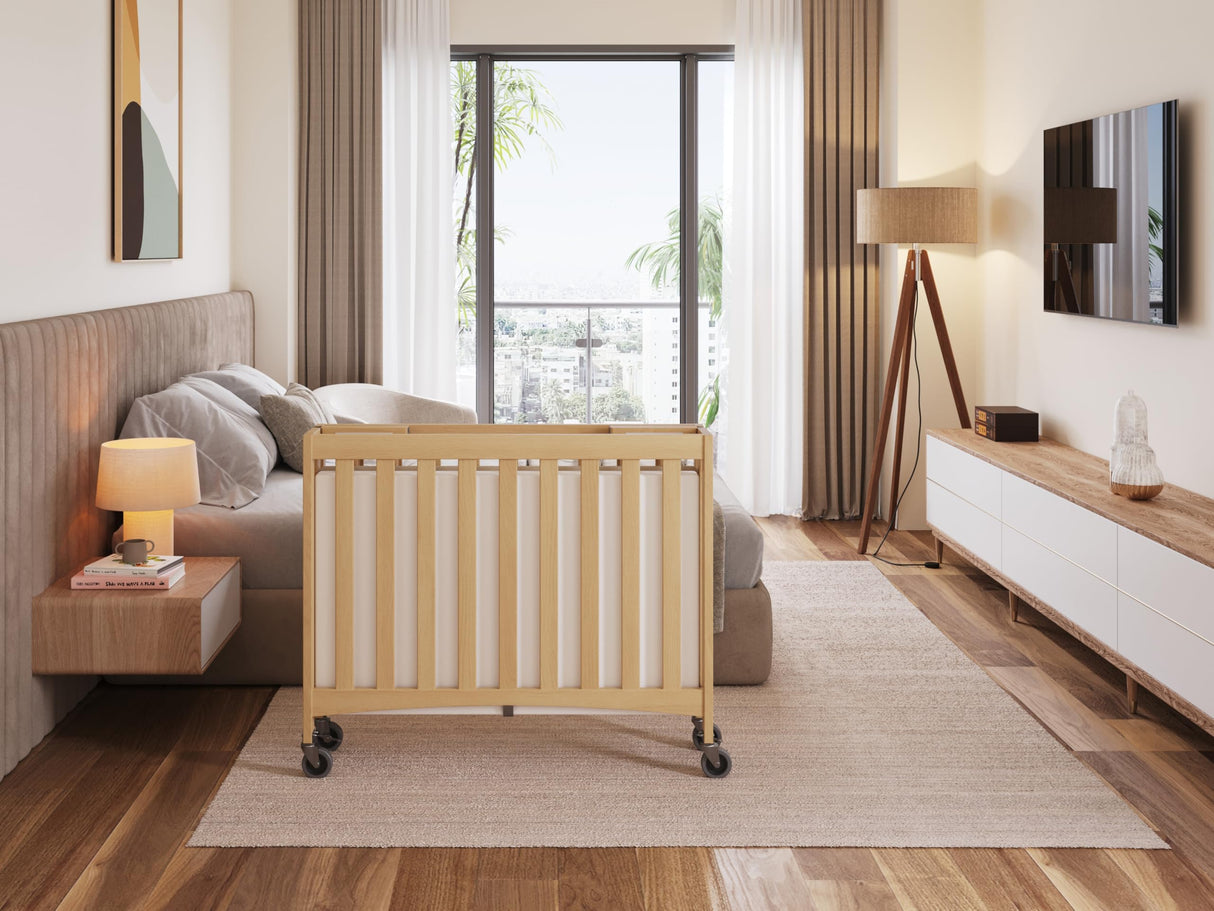 Foundations Travel Sleeper Compact Wooden Folding Crib, Portable Baby Crib with 2” InfaPure Foam Crib Mattress and Commercial Grade Casters, Hotel Crib (Natural) Foundations