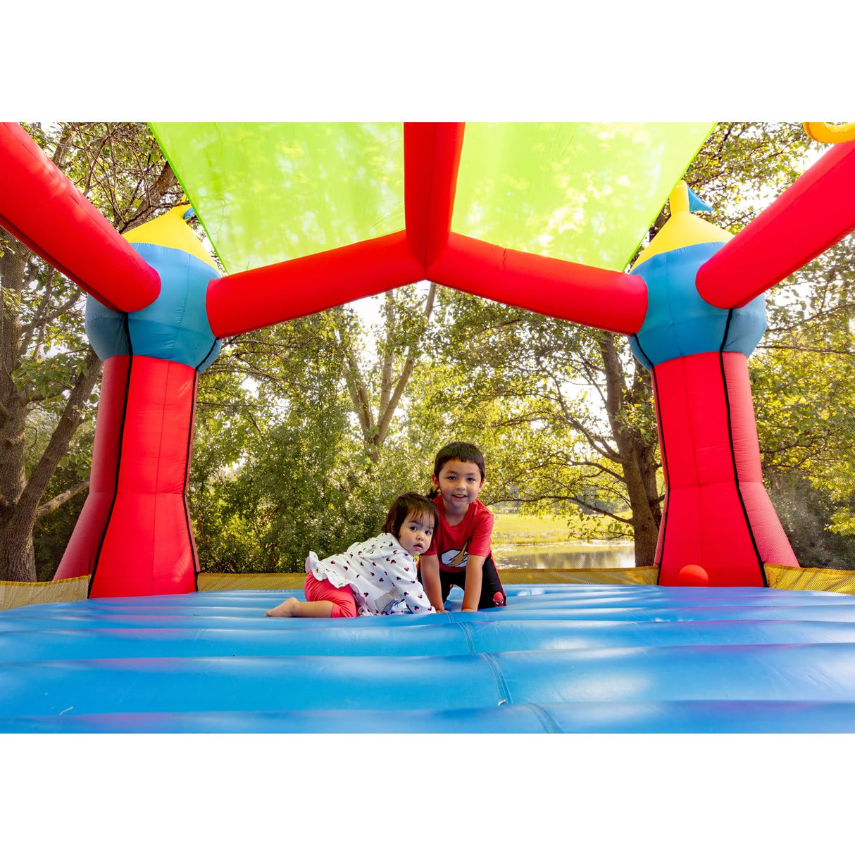 Bounceland Inflatable Party Castle Bounce House Bouncer, 16 ft L x 13 ft W x 10.3 ft H, Basketball Hoop, Removable Sun Roof, UL Strong Blower included, Fun Slide and Bounce Area, Castle Theme for Kids Bounceland