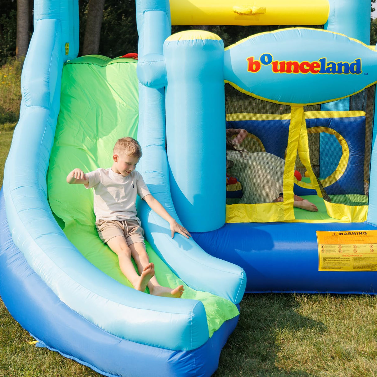 Bounceland Ultimate Combo Inflatable Bounce House, 12 ft L x 10 ft W x 8 ft H, Basketball Hoop, Obstacle Wall, Fun Tunnel, Slide and Bounce Area for Kids Bounceland