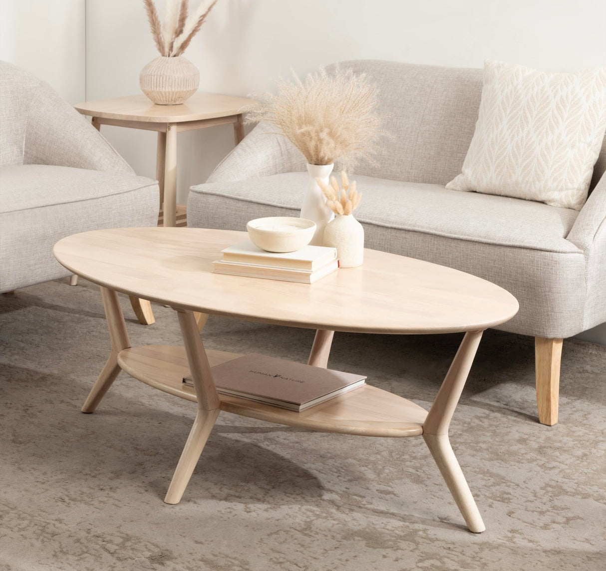Kate and Laurel Nylah Oval Wooden Coffee Table; 48 x 26 x 18; Light Natural; Transitional Tiered Living Room Table with Solid Wood Construction and Sculptured Dowel Legs Kate and Laurel