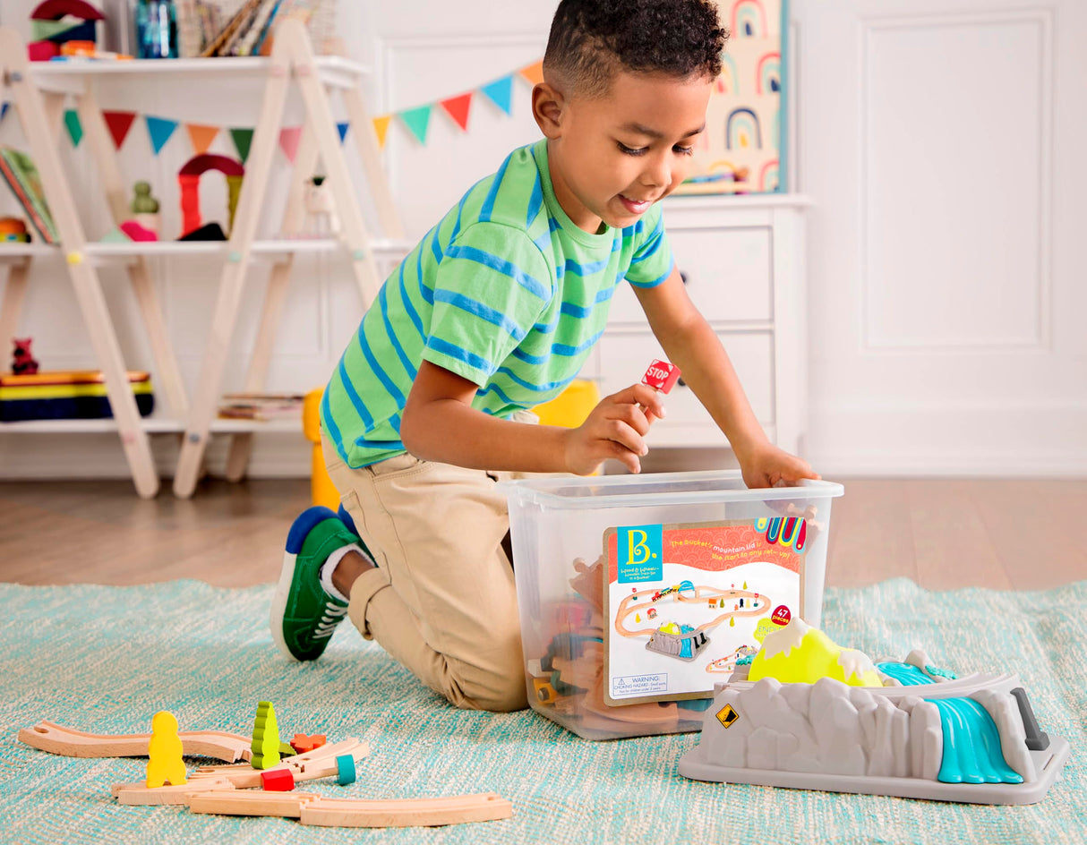 B. toys- Wood & Wheels Train Set- 47pc Wooden Train Set- Train Tracks & Accessories – Storage Bucket with Mountain Lid – Classic Toys for Toddlers, Kids – 3 Years + B. toys