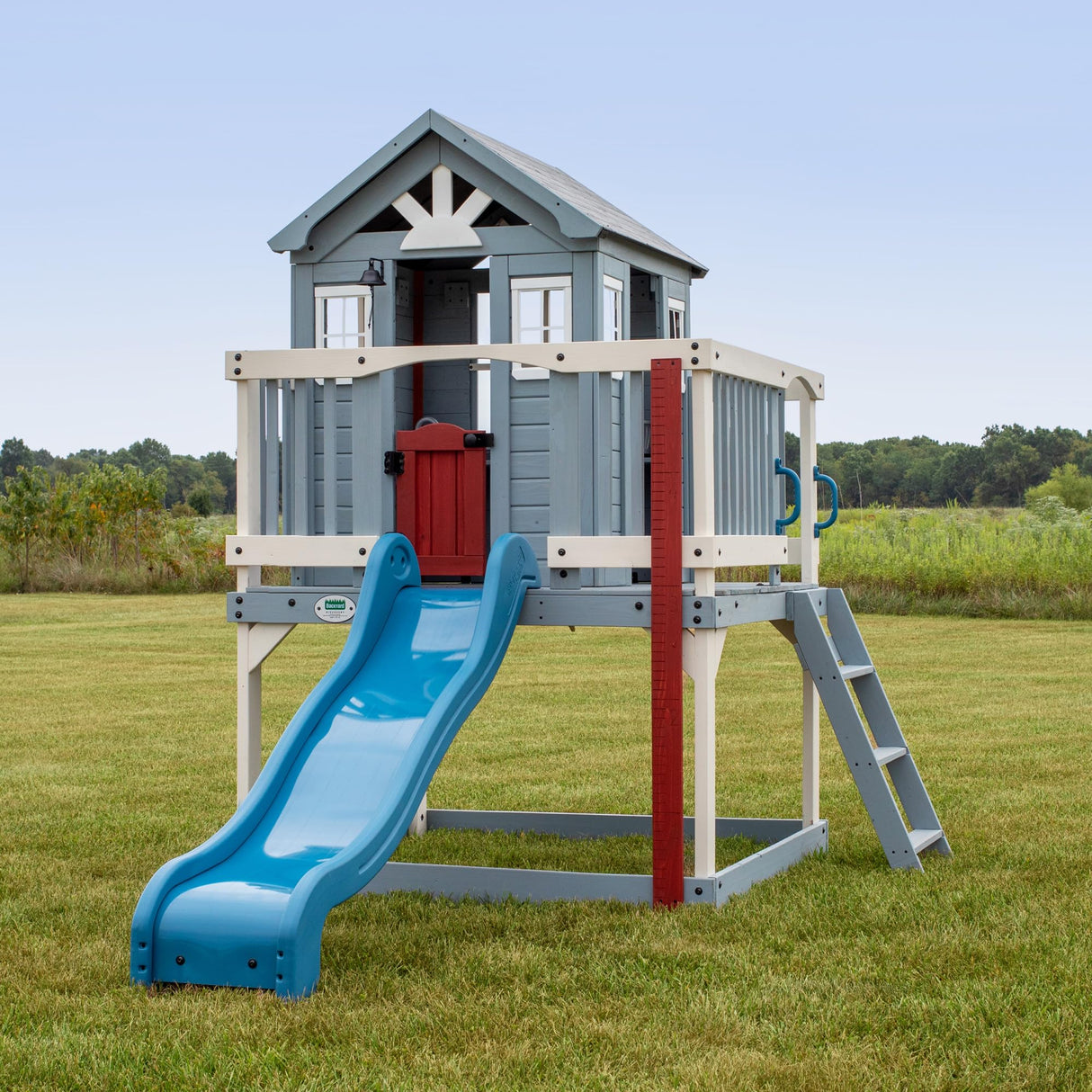 Backyard Discovery Beacon Heights Elevated Cedar Playhouse, Play kitchen, Powered Blender, Working Bell, 6 ft Wave Slide, Wrap-Around Deck, Flat Step Ladder, Growth Chart Backyard Discovery