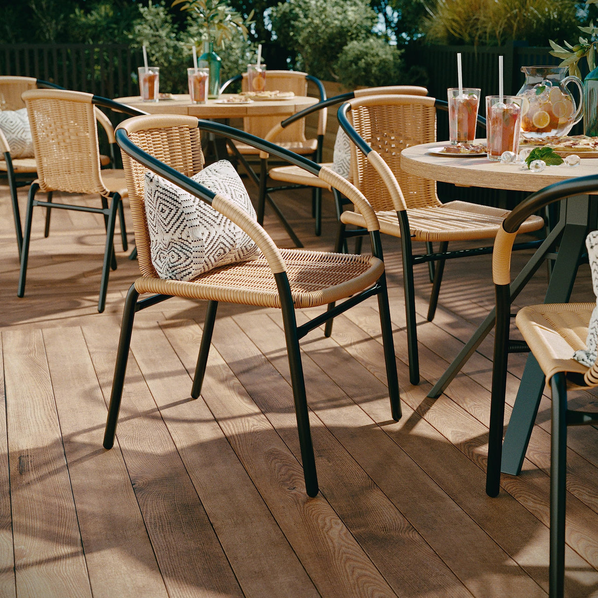 EMMA + OLIVER Set of 4 Modern Rattan Indoor/Outdoor Stack Chairs, Stacking Rattan Patio Chairs with Curved Back and Cross Bracing, Beige EMMA + OLIVER