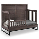 Simmons Kids Foundry 6-in-1 Convertible Baby Crib, Rustic Grey with Matte Black Delta Children