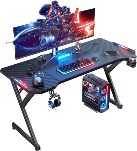 HLDIRECT 63 INCH Gaming Desk with LED Lights, Home Office Gamer Desk, Ergonomic Computer Table with Large Carbon Fiber Desktop, Office Workstation with Mouse Pad, Cup Holder & Headphone Hook, Black HLDIRECT