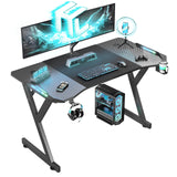 HLDIRECT 47 Inch Gaming Desk with LED Lights, Ergonomic Computer Table with Carbon Fibre Surface, Sturdy PC Workstation Desk for Home Office with Headphone Hook, Cup Holder, Black HLDIRECT