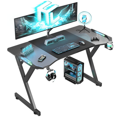 HLDIRECT 47 Inch Gaming Desk with LED Lights, Ergonomic Computer Table with Carbon Fibre Surface, Sturdy PC Workstation Desk for Home Office with Headphone Hook, Cup Holder, Black