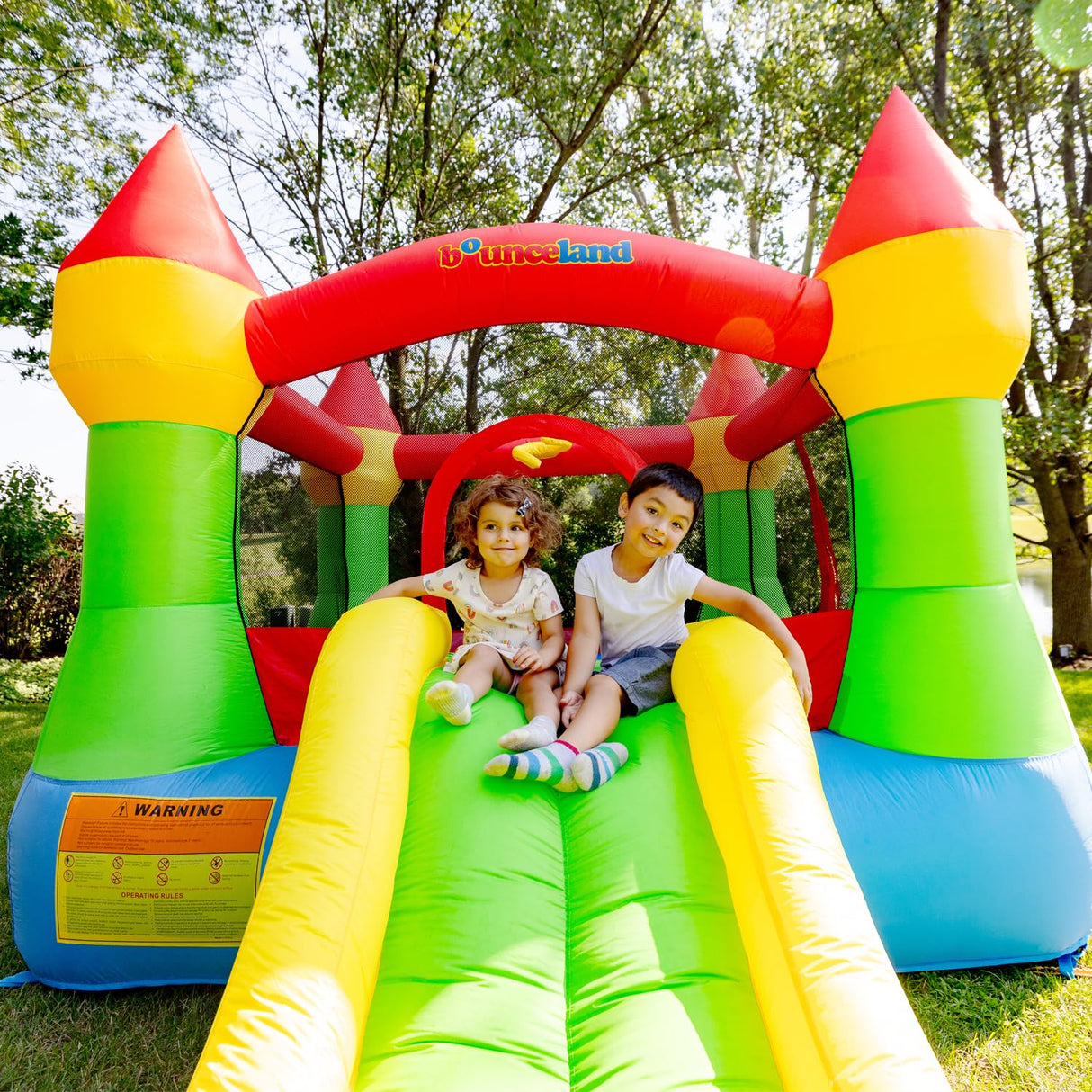 Bounceland Bounce House Castle with Basketball Hoop Inflatable Bouncer, Fun Slide, Safe Entrance Opening, UL Certified Strong Blower Included, 12 ft x 9 ft x 7 ft H Bounceland