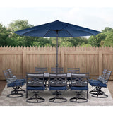 Hanover Montclair 11-Piece Outdoor Dining Set, All-Weather Outdoor Patio Dining Set, 10 Swivel Rocker Chairs with Seat and Lumbar Cushions, 84"x60" Stamped Rectangle Table, Umbrella, and Umbrella Base Hanover