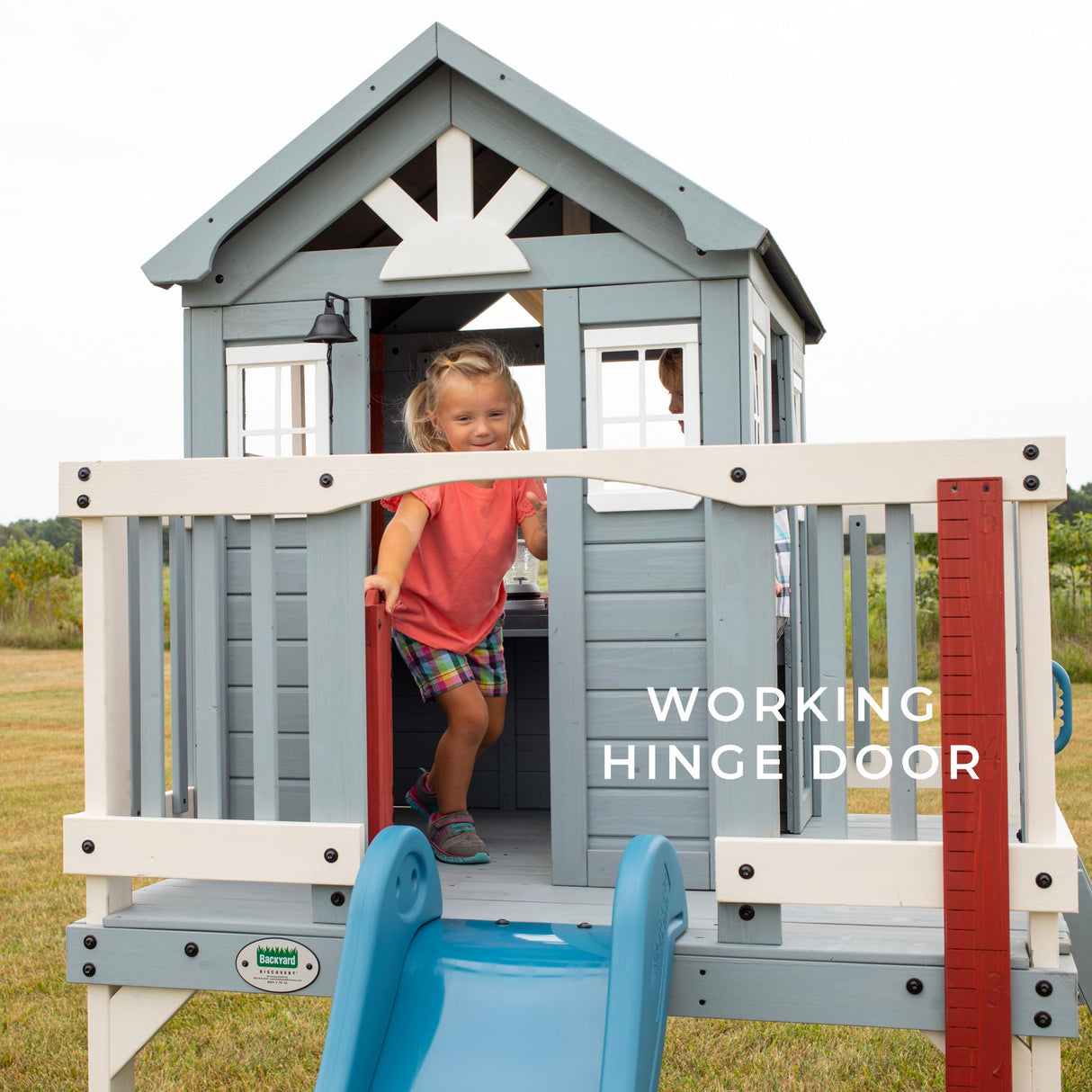 Backyard Discovery Beacon Heights Elevated Cedar Playhouse, Play kitchen, Powered Blender, Working Bell, 6 ft Wave Slide, Wrap-Around Deck, Flat Step Ladder, Growth Chart Backyard Discovery