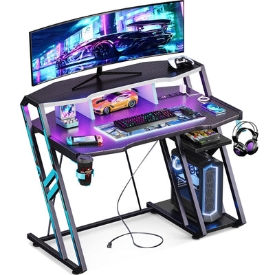 MOTPK Gaming Desk with Power Outlet & LED Lights, Gaming Computer Desk 39inch with PC Storage Shelf, Gaming Table with Carbon Fiber Texture, Gamer Desk, Gift for Boys Men, Black