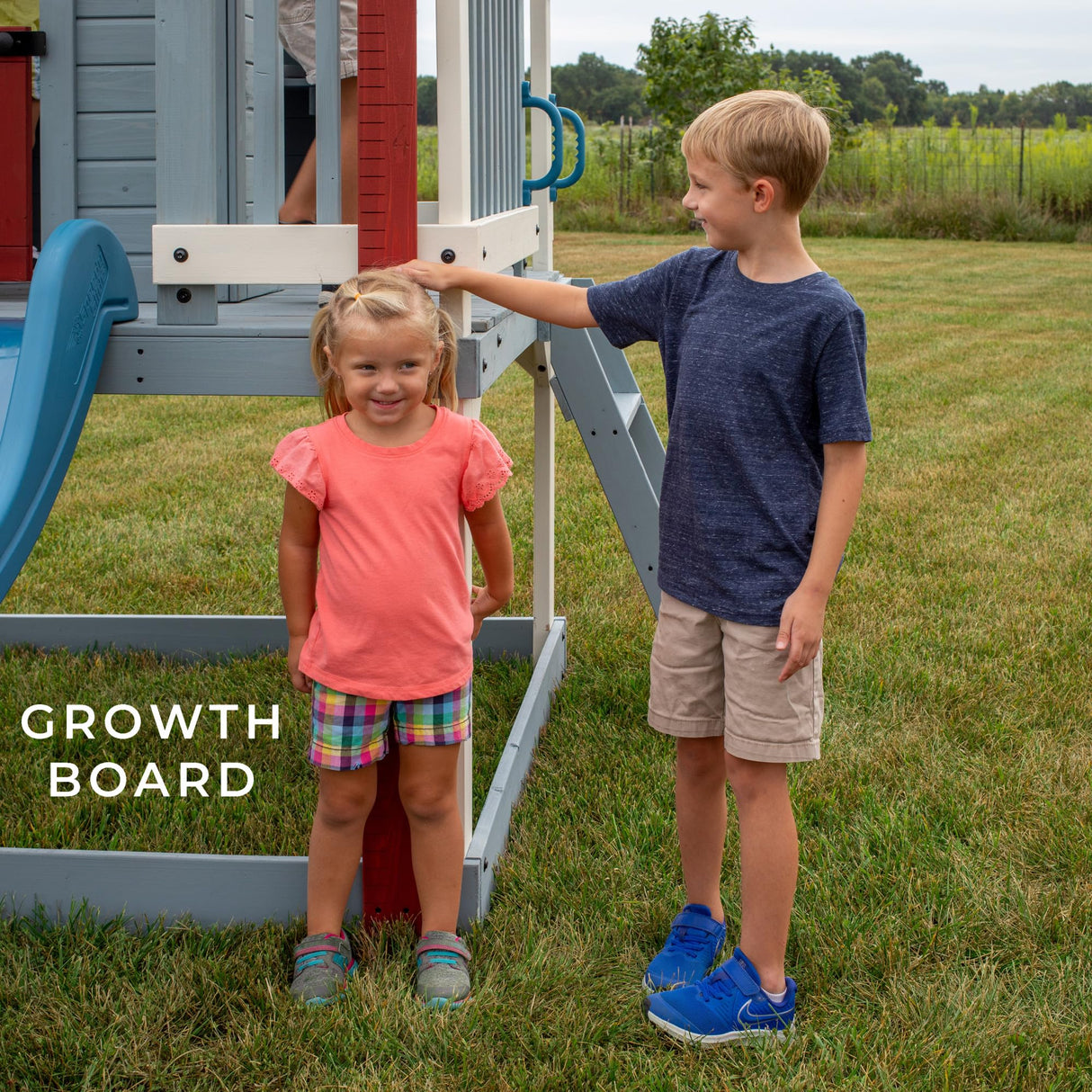 Backyard Discovery Beacon Heights Elevated Cedar Playhouse, Play kitchen, Powered Blender, Working Bell, 6 ft Wave Slide, Wrap-Around Deck, Flat Step Ladder, Growth Chart Backyard Discovery