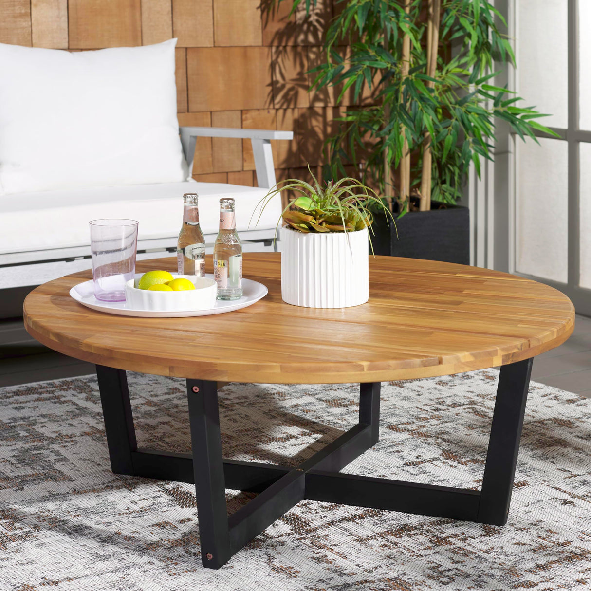 SAFAVIEH Outdoor Collection Leo Natural/Black 4-Leg Round Coffee Table, Ideal for Deck, Patio, Backyard, Sunroom SAFAVIEH