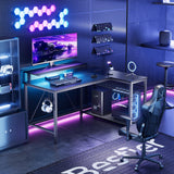 Bestier Gaming Desk with Power Outlets, 42" L-Shaped Gaming Desk with LED Lights, Desk with Reversible Storage Shelves & Hooks for Small Spaces, Bedrooms & Offices, Black Carbon Fiber Bestier
