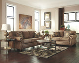 Signature Design by Ashley Larkinhurst Faux Leather Sofa with Nailhead Trim and 2 Accent Pillows, Brown Signature Design by Ashley