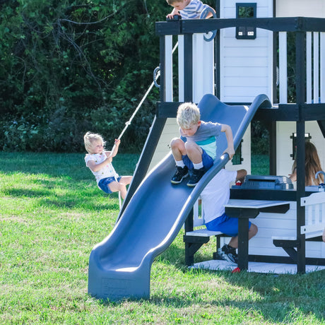 Backyard Discovery Canyon Creek White Cedar Wood Swing Set with Wave Slide, Clubhouse, Play Kitchen, Picnic Area, Belt Swings, Web Swing, Rock Wall, Balconies, Playhouse, Step Ladder, Outdoor Playset Backyard Discovery