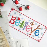 Counted Cross Stitch Kit 'Believe' - Embroidery Set for The Holidays, Encouragement, or Inspiring Everyday Possibilities with a Christmas Tree, Snowflake, Deer and Santa Hat Povitrulya