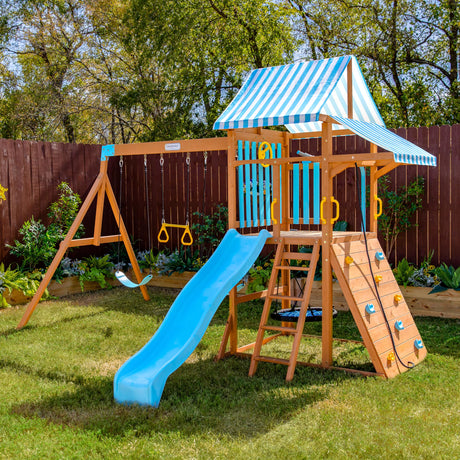 Teamson Kids Wooden Swing Sets for Backyard Outdoor Playset with Slide Rock Wall Trapeze Bar Fireman Pole Pirate Wheel Kids Playground with Swingset Holds 9 Children Ages 3 to 10 Teamson Kids