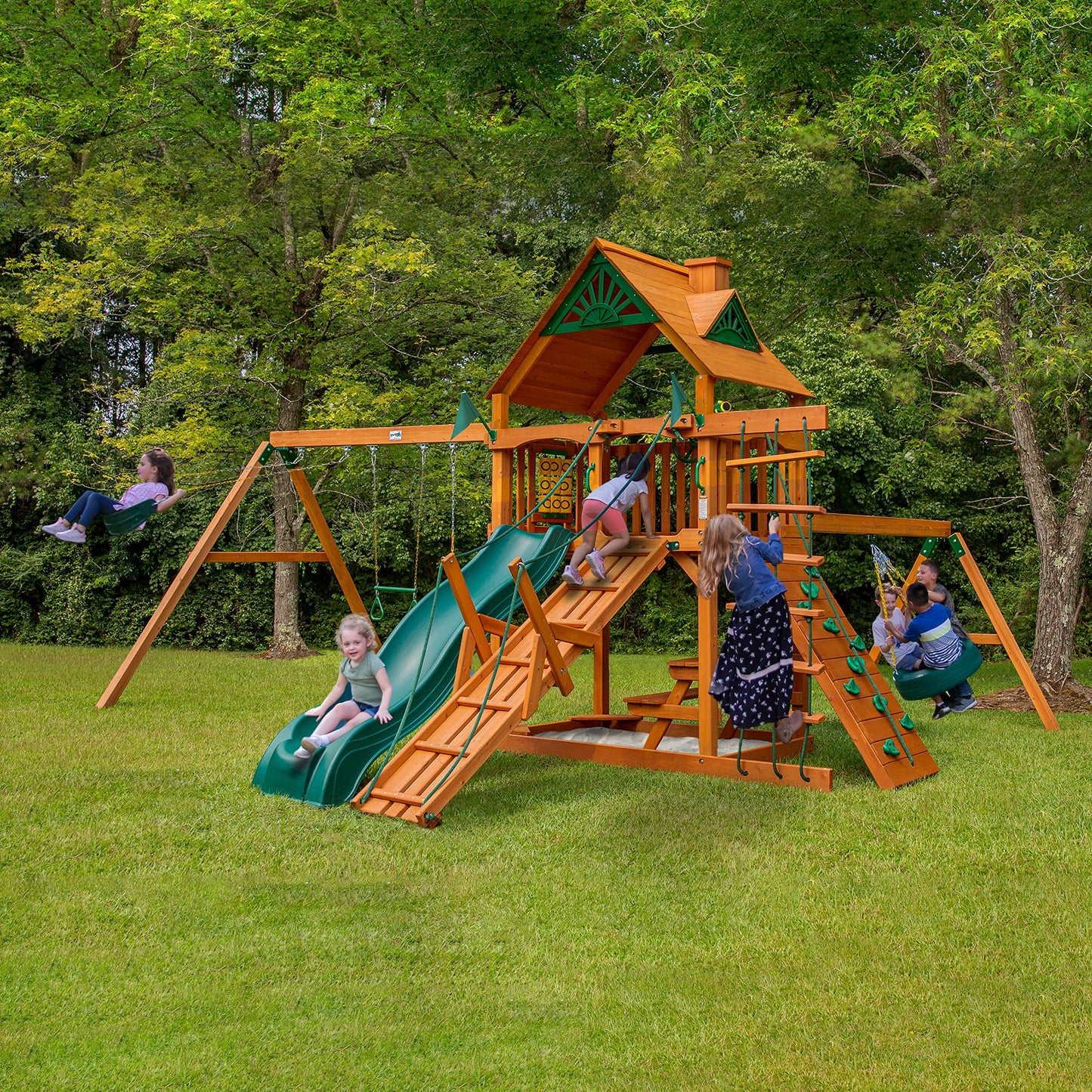 Gorilla Playsets 01-0004-AP Frontier Wood Swing Set with Wood Roof, Tire Swing, Two Belt Swings, Picnic Table, Sandbox, Rock Climbing Wall, Amber