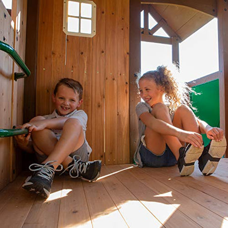 Backyard Discovery Skyfort All Cedar Swing Set, Elevated Covered Wood Roof Clubhouse with Bay Windows, 2 Belt Swings, Web Swing, 10ft Wave Slide, 5 Backyard Discovery